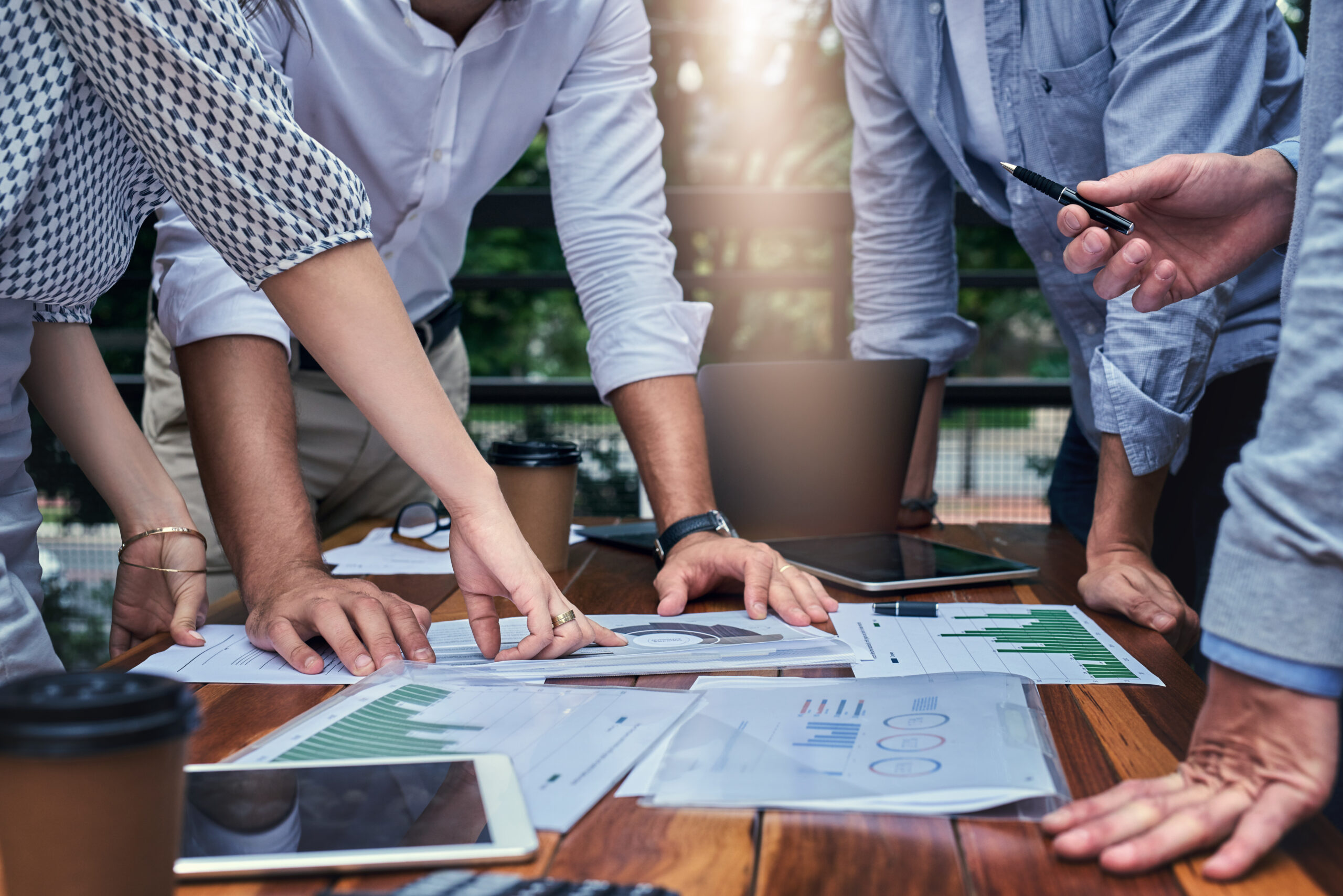 Business people, hands and paper for statistics at coffee shop, campaign research and productivity. Employees, documents and public relations agency for social media analysis, report and planning, signifying Agencies