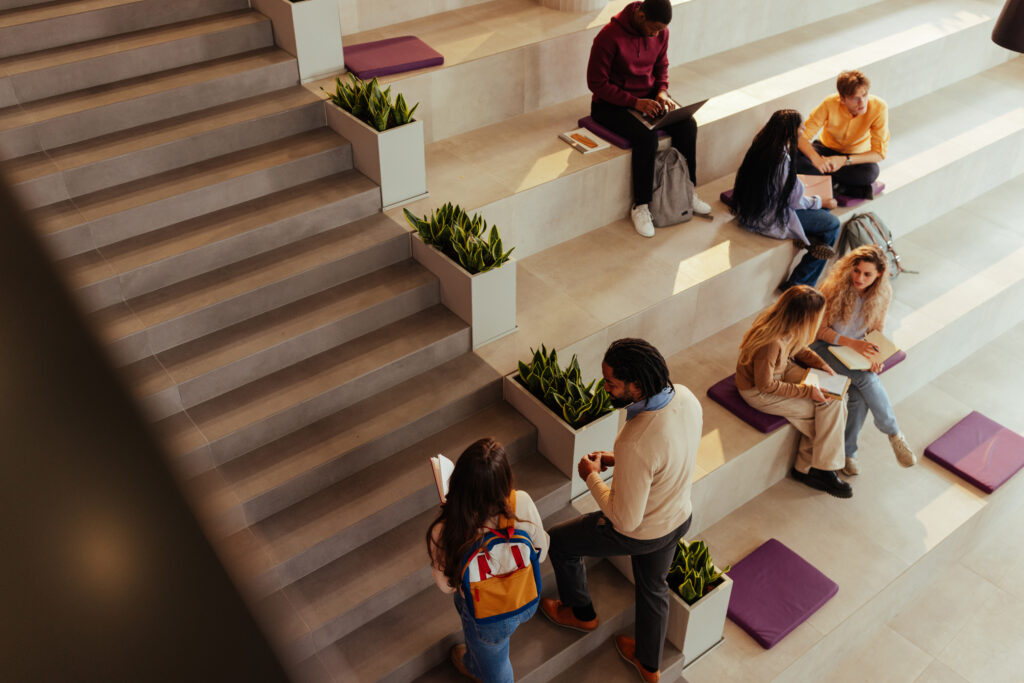University students collaborating and studying in modern campus area